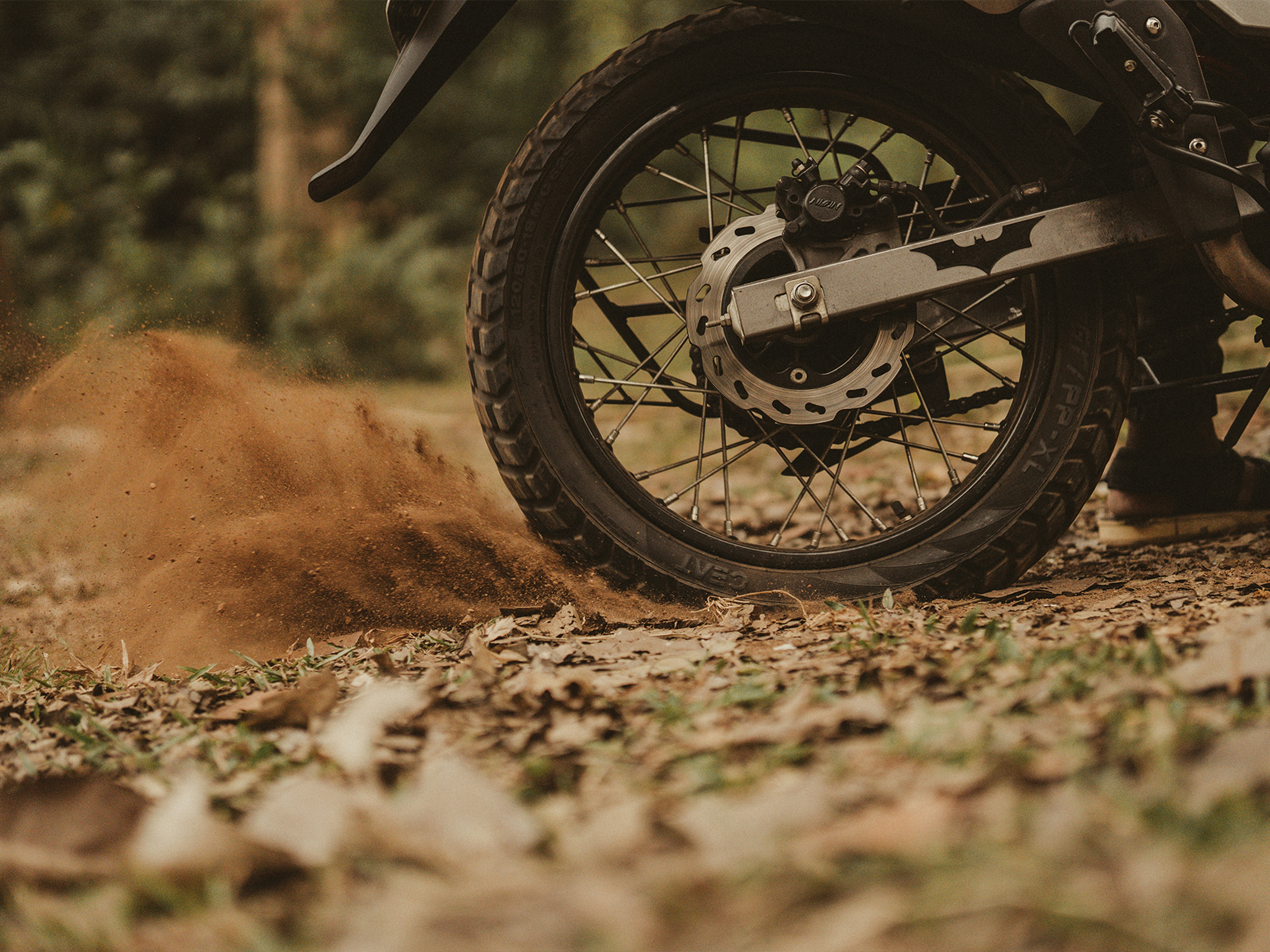 black motorcycle wheel on brown dirt road